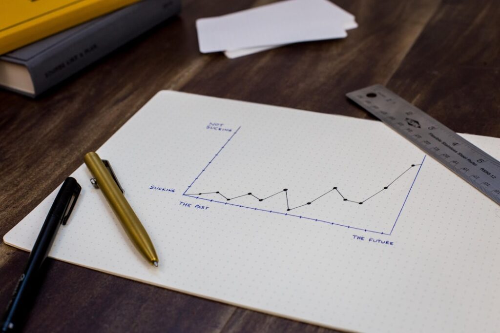 Hand-drawn growth chart on paper showing upward trend line, representing SEO ROI and business growth over time