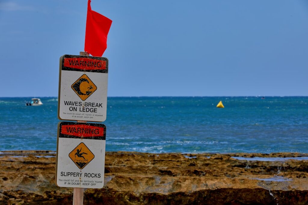 Red warning flags indicating dangerous conditions, representing the risks of ultra-cheap SEO services
