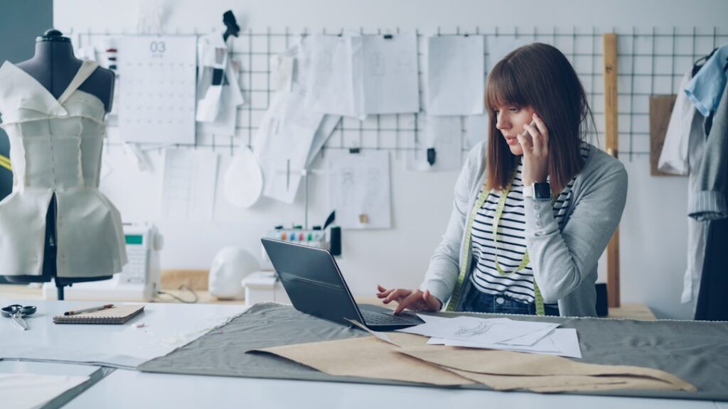 Small business owner working independently while consulting with professionals, representing the DIY vs agency decision