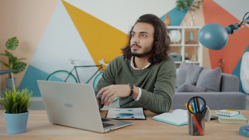 Freelancer working alone at desk with laptop, representing the independent SEO consultant option for small businesses