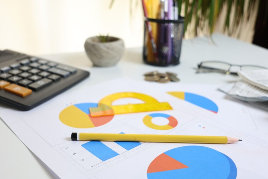 Budget planning workspace with colorful charts, calculator and pencil showing small business financial planning